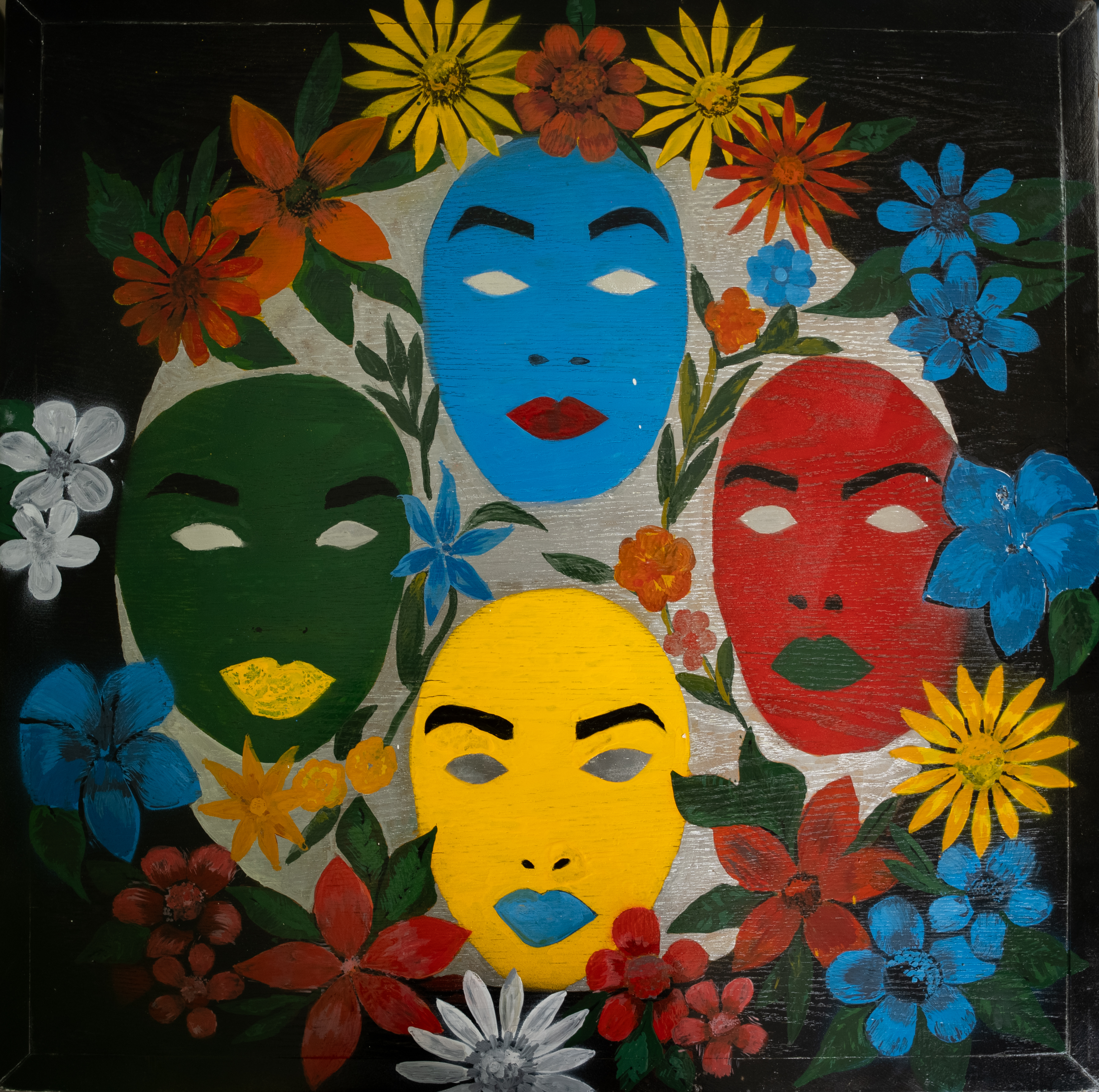 Four brightly coloured faces surrounded by flowers against a dark ground