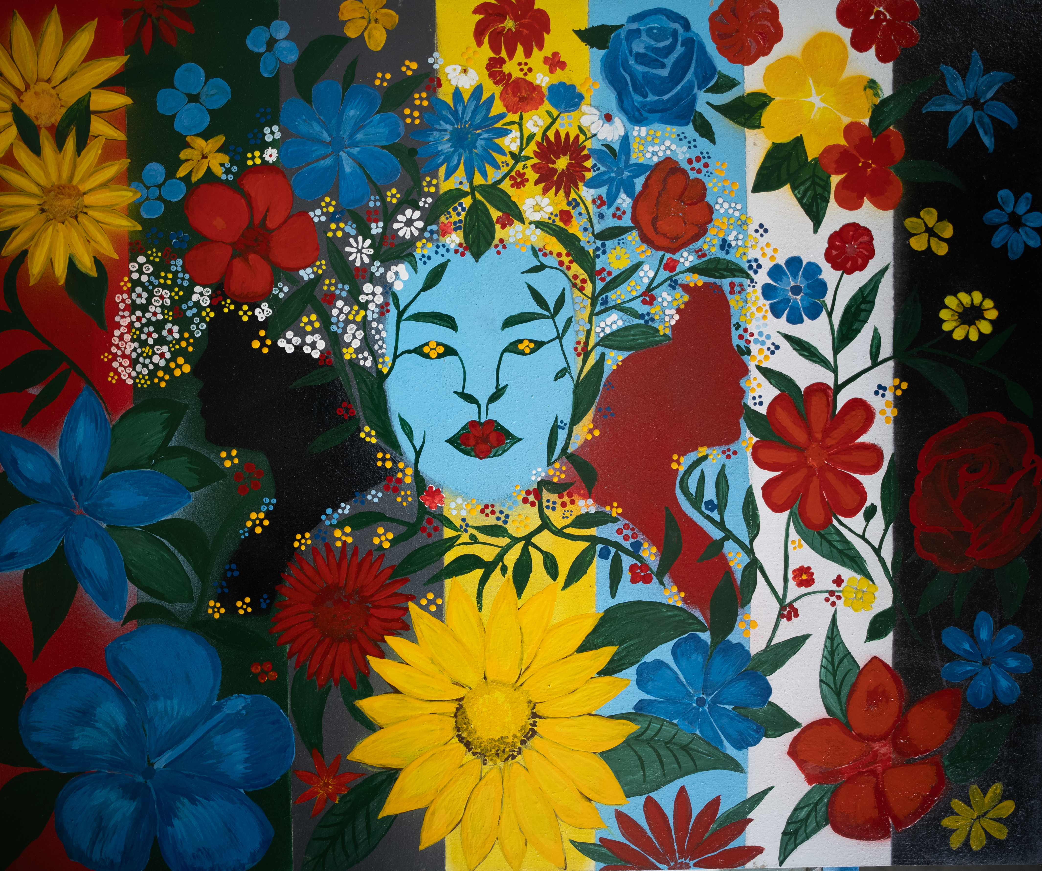 Pale blue face surrounded by an abundant field of colourful flowers